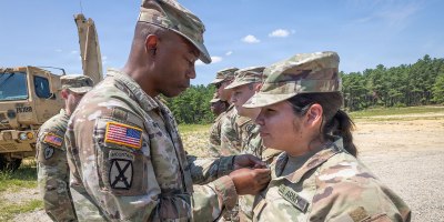 U.S. Army Col. Omar Minott, commander, 44th Infantry Brigade Combat Team, New Jersey Army National Guard, left, presents the Army Achievement Medal to 2nd Lt. Anthuanet C. Gomez-Blacido, platoon leader, 3rd Battalion, 112th Field Artillery Regiment, 44th IBCT, at an awards ceremony at Joint Base McGuire-Dix-Lakehurst, New Jersey, July 24, 2026.