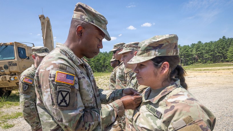 U.S. Army Col. Omar Minott, commander, 44th Infantry Brigade Combat Team, New Jersey Army National Guard, left, presents the Army Achievement Medal to 2nd Lt. Anthuanet C. Gomez-Blacido, platoon leader, 3rd Battalion, 112th Field Artillery Regiment, 44th IBCT, at an awards ceremony at Joint Base McGuire-Dix-Lakehurst, New Jersey, July 24, 2026.