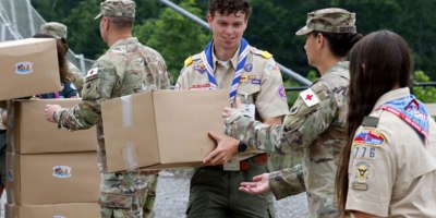 West Virginia and The Connecticut National Guard Soldiers lent a hand to load 2,500 UMCOR - United Methodist Committee On Relief hygiene kits assembled this week by Scouts and Jamboree volunteers in addition to the normal donation of almost 2,500 cleaning bucket kits.