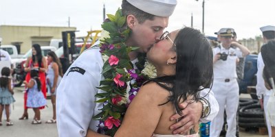 A U.S. Navy Sailor assigned to Virginia-class fast-attack submarine USS Minnesota (SSN 783) kisses his family as Minnesota returns to its homeport at Naval Base Guam, July 29, 2026.