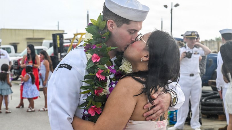 A U.S. Navy Sailor assigned to Virginia-class fast-attack submarine USS Minnesota (SSN 783) kisses his family as Minnesota returns to its homeport at Naval Base Guam, July 29, 2026.