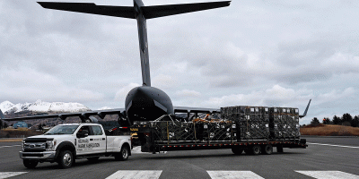 A truck transports medical equipment unloaded from a U.S. Air Force C-17 Globemaster III aircraft in support of Kodiak Arctic Care 2026, May 9, 2026, Kodiak Air Station, Alaska. Kodiak Arctic Care 2026, a Depart of War sponsored Innovative Readiness Training program, in partnership with the Kodiak Area Native Association, provides no cost medical, dental and vision services to residents of Kodiak, Alaska and its remote villages while providing training for Reserve and Guard members. (U.S. Air Force photo by 1st Lt. Heather Cozad Staley)