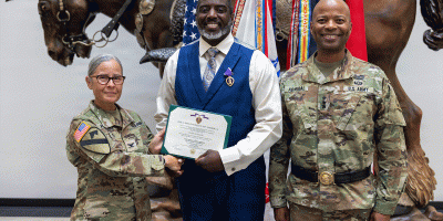 Retired U.S. Army Sgt. 1st Class Thomas Wardale III, center, poses for a photo with Col. Pily Restrepo, deputy commanding officer of the 13th Armored Sustainment Command, left, and Lt. Gen. Kevin D. Admiral, commanding general of III Armored Corps, after receiving the Purple Heart during a ceremony on July 8, at III Armored Corps Headquarters at Fort Hood. (U.S. Army photo by Spc. Patrick M. Connery)