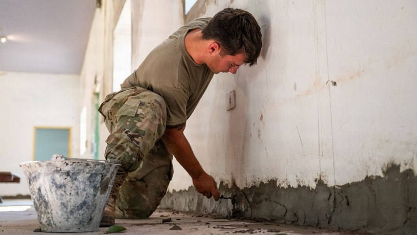 U.S. Air Force Airman 1st Class Riley Howland, a structural specialist with the 102nd Civil Engineer Squadron, Massachusetts Air National Guard, applies mortar along a wall during renovation work at Centro de Entrenamiento Conjunto de Operaciones de Paz (CECOPAZ), the Joint Peace Operations Training Center, in Asunción, Paraguay, July 16, 2026.