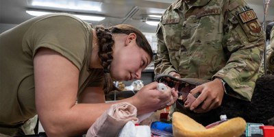 U.S. Army Corporal Piper McIntosh and U.S. Air Force Technical Sgt. Milos Garcia Chabelley Airfield Joint Medical Aid Station medics practice placing an airway into a “Diesel Dog” training simulator during the K-9 Tactical Combat Casualty Care training at Chabelley Airfield, Djibouti, July 24, 2026.