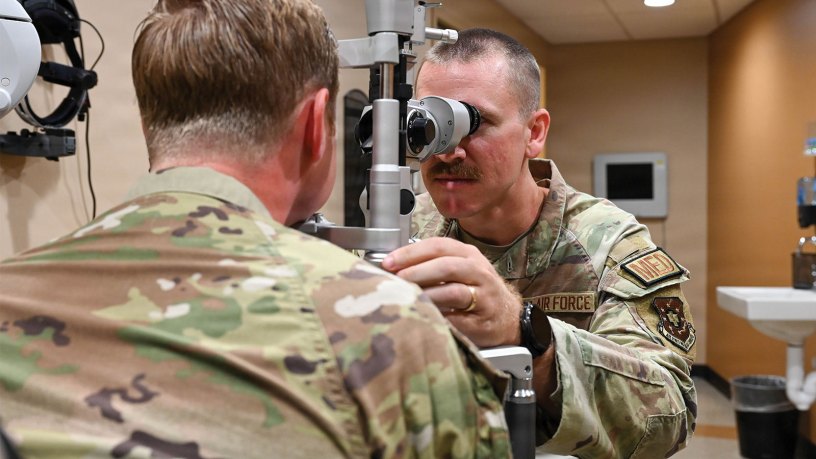 U.S. Air Force Capt. Max Sarver, right, Luke Medical Group Operational Medical Readiness Squadron optometry element chief, performs an eye exam at Luke Air Force Base, Arizona, July 29, 2026.
