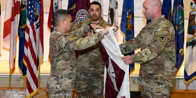 Col. Joselito "Joe" Lim, left, commander of the U.S. Army Medical Materiel Agency, inspects the unit colors during a USAMMA discontinuation ceremony July 31, 2026, at Fort Detrick, Maryland. Also pictured are Staff Sgt. Tereso Hernandez and Sgt. Maj. Todd Brenecki. Photo by C.J. Lovelace.