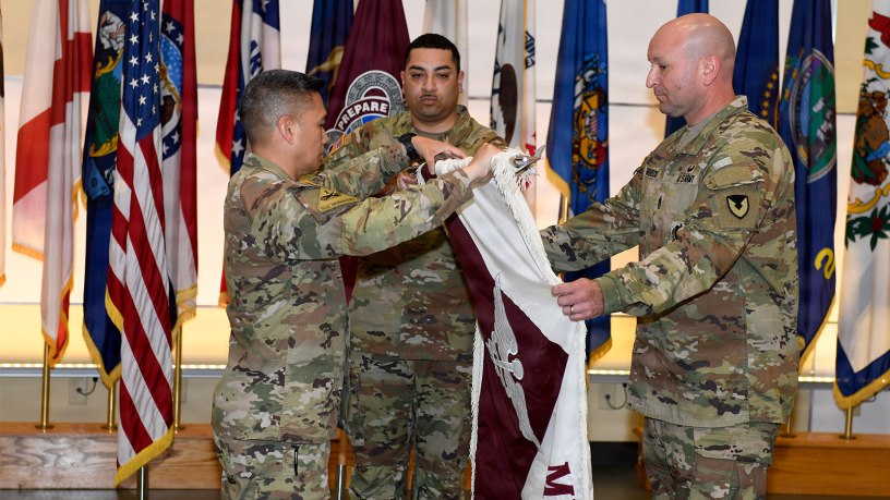 Col. Joselito "Joe" Lim, left, commander of the U.S. Army Medical Materiel Agency, inspects the unit colors during a USAMMA discontinuation ceremony July 31, 2026, at Fort Detrick, Maryland. Also pictured are Staff Sgt. Tereso Hernandez and Sgt. Maj. Todd Brenecki. Photo by C.J. Lovelace.