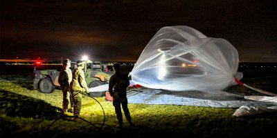 Soldiers assigned to Multi-Domain Command-Europe inflate a high-altitude balloon before launch during nighttime operations in Powidz, Poland, July 28, 2026.