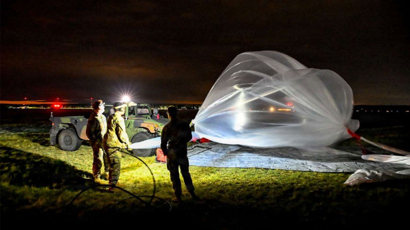 Soldiers assigned to Multi-Domain Command-Europe inflate a high-altitude balloon before launch during nighttime operations in Powidz, Poland, July 28, 2026.