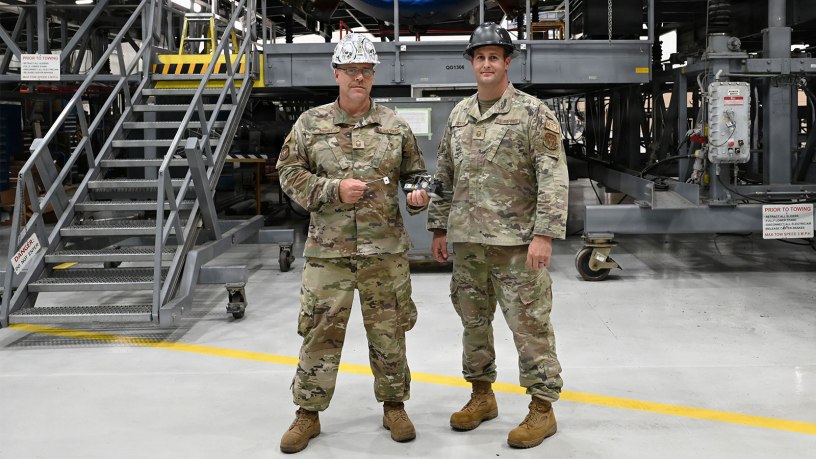 Senior Master Sgt. Chad Bryant (left) and Master Sgt. Tyler Dickson, 512th Maintenance Squadron maintainers, display their creation, a gauge for a variable stator vane lever linkages rigging set for a C-5M Super Galaxy aircraft, at Dover Air Force Base, Delaware, Aug. 1, 2026.