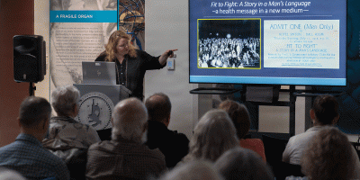 National Museum of Health and Medicine's Chief Archivist, Laura Cutter, highlights archival materials from the NMHM collections to illustrate the different techniques used for education and to influence behavioral choices on the challenges of sexually trasmitted diseases during World Wars I and II during a lecture on Aug. 2, 2026 in Silver Spring MD. (National Museum of Health and Medicine photo by Chuck Kennedy)