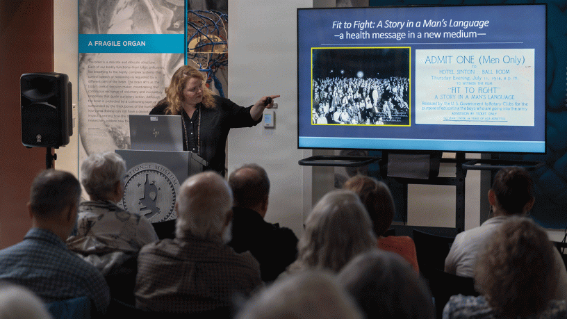 National Museum of Health and Medicine's Chief Archivist, Laura Cutter, highlights archival materials from the NMHM collections to illustrate the different techniques used for education and to influence behavioral choices on the challenges of sexually trasmitted diseases during World Wars I and II during a lecture on Aug. 2, 2026 in Silver Spring MD. (National Museum of Health and Medicine photo by Chuck Kennedy)