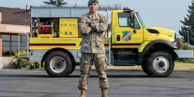 U.S. Air Force Master Sgt. Eric McNair, 92nd Operations Group first sergeant, stands in front of an attack fire apparatus for an environmental portrait at Spokane County Fire District #3, Cheney, Washington, Aug 5., 2026.
