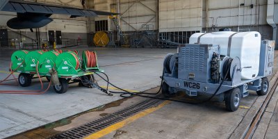 An Airman-designed aircraft engine compressor wash cart is connected to an AC-130J Ghostrider assigned to the 1st Special Operations Wing at Hurlburt Field, Florida, Aug. 6, 2026. The upgraded cart enables maintainers to wash all four engines in a single cycle, reducing standard wash times by 75% and reducing overall ground maintenance hours. (U.S. Air Force photo by Airman Olivia Perkins)