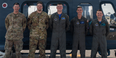 Tech. Sgt. Homer Miller, Malmstrom Operational Medical Readiness Squadron flight medicine section chief, Senior Airman Dakota Doss, 40th Helicopter Squadron (HS) special missions aviator, Staff Sgt. Owen Anderson, 40th HS weapons and tactics noncommissioned officer in charge, Capt. Aaron Sanders, 550th HS standards and evaluation officer, and Capt. Jacques Soto, 40th HS MH-139A chief of standards and evaluations, pose for a photo in front of an MH-139A Grey Wolf helicopter at Malmstrom Air Force Base, Montana, Aug. 7, 2026.