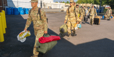 Oregon Air National Guard airmen with the 142nd Wing and 173rd Fighter Wing arrive by charter bus at Anderson Readiness Center in Salem, Ore., Aug. 7, 2026, to begin Joint Reception, Staging, Onward Movement and Integration ahead of deploying as part of two 22-person hand crews supporting wildland firefighting efforts on the Grasshopper Fire in the Mount Hood National Forest.