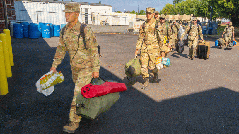 Oregon Air National Guard airmen with the 142nd Wing and 173rd Fighter Wing arrive by charter bus at Anderson Readiness Center in Salem, Ore., Aug. 7, 2026, to begin Joint Reception, Staging, Onward Movement and Integration ahead of deploying as part of two 22-person hand crews supporting wildland firefighting efforts on the Grasshopper Fire in the Mount Hood National Forest.