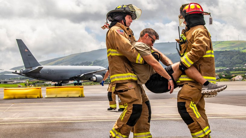 U.S. Air Force Master Sgt. David Denlis, a firefighter with the 121st Air Refueling Wing, and the Lajes Field Fire Department, simulate a motor vehicle accident scenario at Lajes Field, Portugal, on August 10, 2026.