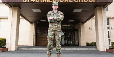 U.S. Air Force Capt. Zachary Hicks, 374th Health Care Operations Squadron, family medicine physician, poses for a photo outside the 374 HCOS at Yokota Air Base, Japan, Aug. 11, 2026.