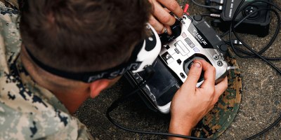 U.S. Marine Corps Lance Cpl. Christian Gillham, a mortarman and team leader with 3rd Littoral Combat Team, 3rd Marine Littoral Regiment, 3rd Marine Division, flies a first-person view unmanned aircraft system for a long-range simulated strike during the Marine Corps Attack Drone Competition at Marine Corps Base Quantico, Virginia, Aug. 11, 2026.