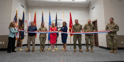 Pictured left to right: Nancy Maloy, NSWC Crane Platform Protection & Countermeasures Technologies Division Manager, Marty Terry, NSWC Crane Countermeasures Assessment Branch Manager, Brigadier General Cathy Eaken, Congresswoman Erin Houchin, Dr. Angela Lewis (SES), Technical Director, NSWC Crane, COL Russell “Bubba” Strange, COL Daniel Bell, and Command Sgt Maj. Brad Simmons at the ribbon cutting for the nation’s first ground-based Sled Track Facility at Camp Atterbury in Indiana.