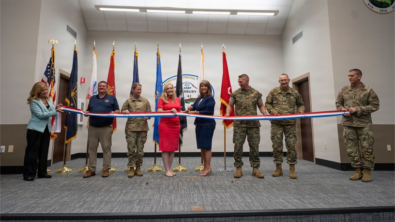 Pictured left to right: Nancy Maloy, NSWC Crane Platform Protection & Countermeasures Technologies Division Manager, Marty Terry, NSWC Crane Countermeasures Assessment Branch Manager, Brigadier General Cathy Eaken, Congresswoman Erin Houchin, Dr. Angela Lewis (SES), Technical Director, NSWC Crane, COL Russell “Bubba” Strange, COL Daniel Bell, and Command Sgt Maj. Brad Simmons at the ribbon cutting for the nation’s first ground-based Sled Track Facility at Camp Atterbury in Indiana.