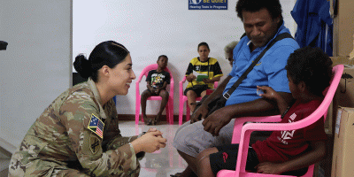Staff Sgt. Susana Castillo, Team Sergeant, USARPAC Oceania Engagement Team, distributes hearing protection. (Photo by Staff Sgt. Susana Castillo)
