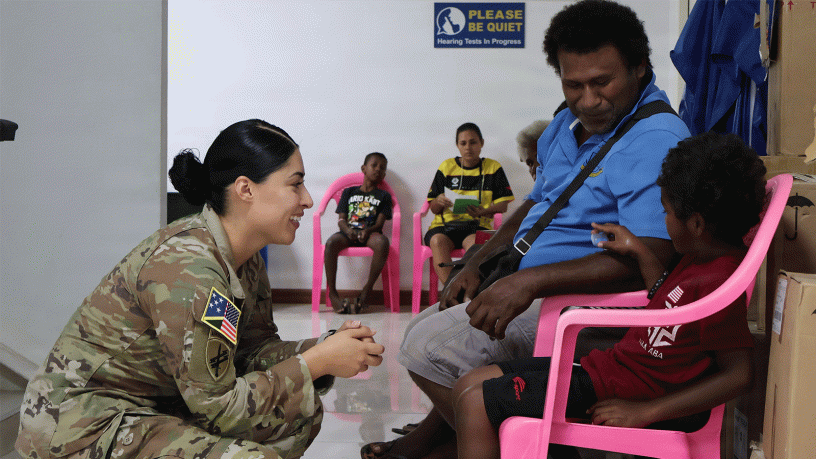 Staff Sgt. Susana Castillo, Team Sergeant, USARPAC Oceania Engagement Team, distributes hearing protection. (Photo by Staff Sgt. Susana Castillo)