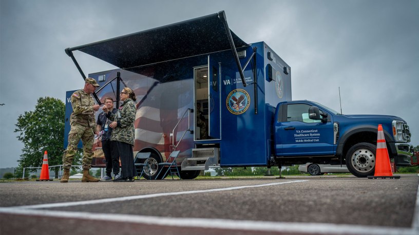 A Soldier assigned to the Connecticut National Guard's 1st Battalion, 102nd Infantry Regiment talks with a member of the Connecticut Department of Veterans Affairs Mobile Medical Team during his Reverse Solider Readiness Processing at Camp Nett, Niantic, Connecticut, Aug. 17, 2026.