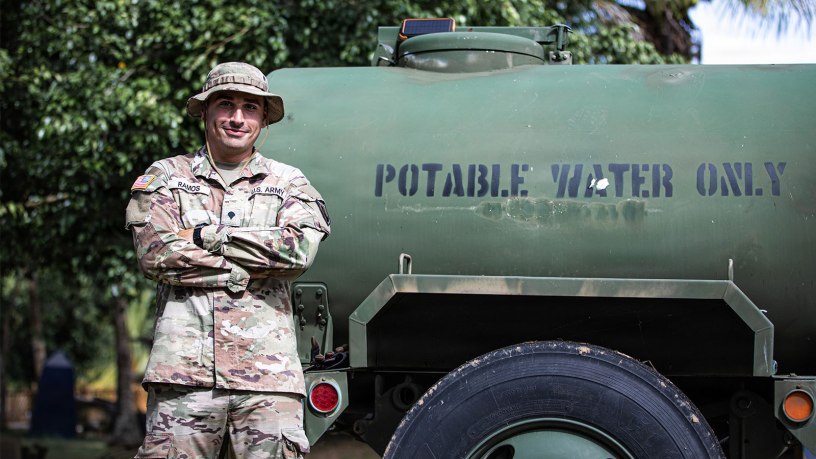U.S. Army Spc. Jesús D. Ramos, a water treatment specialist assigned to the 105th Quartermaster Water Purification and Distribution Company, 191st Regional Support Group, Puerto Rico Army National Guard, stands beside a potable-water tanker at a water purification site in Canóvanas, Puerto Rico, Aug. 20, 2026.