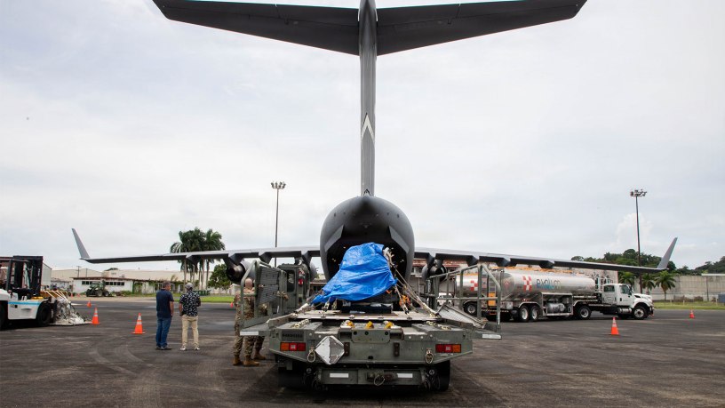 U.S. Air Force service members from the 21st Airlift Squadron and the 621st Contingency Response Wing, assigned to Travis Air Force Base, California, along with Panamanian partners prepare to load an irradiator into a C-17 Globemaster III in Panama Pacifico, Panama, Aug. 23, 2026.