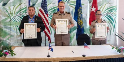From left, Chris Debrum, director of the Republic of the Marshall Islands Office of National Security; Maj. Gen. Craig Strong, adjutant general of the Nebraska National Guard; and Brig. Gen. Karin Watson, adjutant general of the Guam National Guard, display the newly signed State Partnership Program agreements in Majuro, Republic of the Marshall Islands, Aug. 25, 2026.