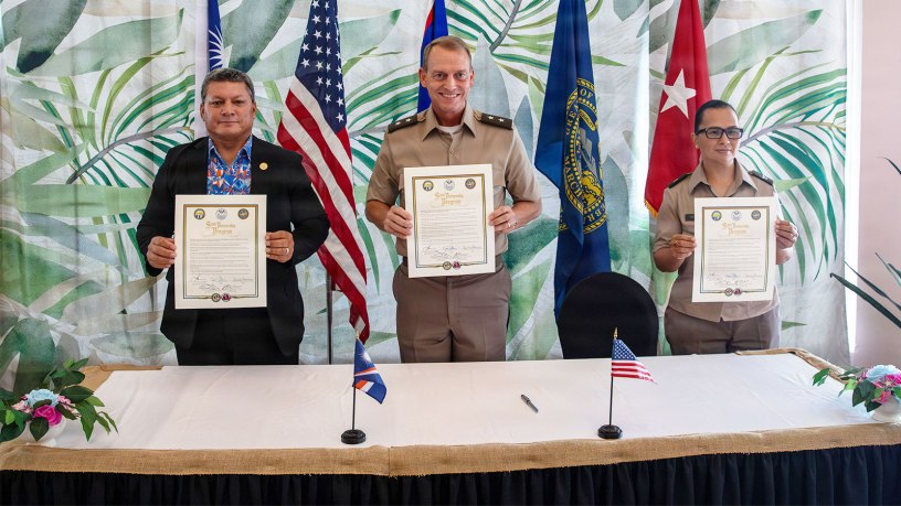 From left, Chris Debrum, director of the Republic of the Marshall Islands Office of National Security; Maj. Gen. Craig Strong, adjutant general of the Nebraska National Guard; and Brig. Gen. Karin Watson, adjutant general of the Guam National Guard, display the newly signed State Partnership Program agreements in Majuro, Republic of the Marshall Islands, Aug. 25, 2026.