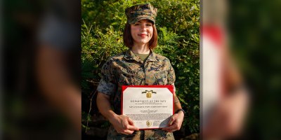 U.S. Marine Corps Cpl. Harleigh Faulk, a combat photographer with Security Battalion, Marine Corps Base Quantico, poses for a photo with her Navy and Marine Corps Achievement Medal on MCB Quantico, Virginia, Aug. 26, 2026.
