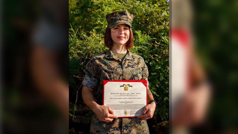 U.S. Marine Corps Cpl. Harleigh Faulk, a combat photographer with Security Battalion, Marine Corps Base Quantico, poses for a photo with her Navy and Marine Corps Achievement Medal on MCB Quantico, Virginia, Aug. 26, 2026.