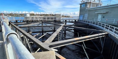 This photograph captures the New Bedford Hurricane Protection Barrier with its elevated walkway and structural framework overlooking the water. The facility is part of the U.S. Army Corps of Engineers infrastructure designed to protect the city from storm surges.