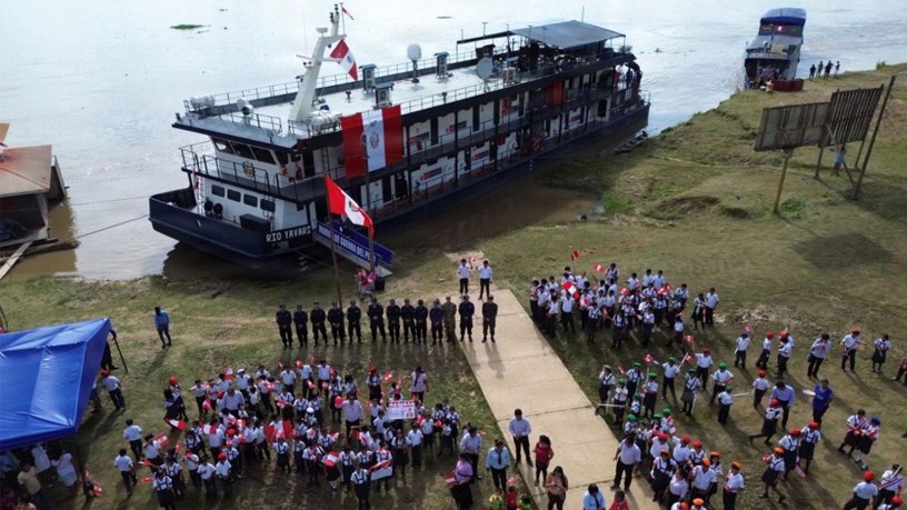 Lt. Bret Peterson, a microbiologist with Naval Medical Research Unit (NAMRU) SOUTH, poses with the locals on the BAP Río Yavari during a welcome ceremony in a community on the Amazon River.