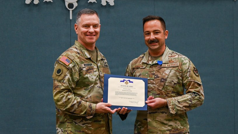 Maj. Gen. Matthew Woodruff, left, Ohio adjutant general, presents the Ohio Cross to Capt. Paul Dangelo, of the 178th Wing, during a ceremony in Springfield, Ohio, June 11, 2026.
