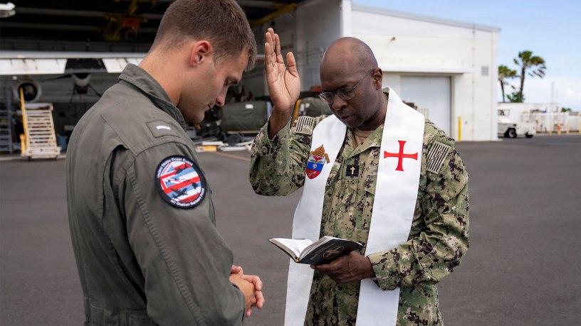 U.S. Navy Chaplain Father Mark Bristol, prays over Lt.j.g. Gunnar Brodfuehrer, a MH-60T Jayhawk helicopter pilot assigned to Coast Guard Air Station Barber's Point in Kapolei, Hawaii, July 15, 2026.