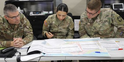 Col. David Rigg and Spc. Reyna Gonzalez, U.S. Army Soldiers assigned to the 167th Theater Sustainment Command, and Sgt. Chandler Cook, U.S. Army Soldier assigned to the 731st Combat Sustainment Support Battalion, discuss best methods to develop a wide area search team during a Texas A&M Engineering Extension Service (TEEX) National Emergency Response and Recovery Training Center Wide Area Search Course.