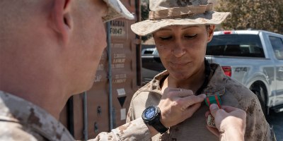 U.S. Navy Petty Officer 3rd Class Valeria Carmona, a hospital corpsman, with the 1st Battalion, 6th Marine Regiment, 2nd Marine Division, receives a Navy and Marine Corps Achievement Medal from Lt. Col. Keegan Kinkade the battalion commander of the 1st Battalion, 7th Marine Regiment, 1st Marine Division, both assigned to Joint Task Force-Southern Border (JTF-SB) in support of Operation Ardent Vanguard, during an award ceremony near Campo, California, Aug. 15, 2026.