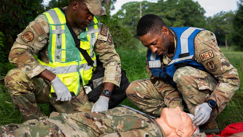 Staff Sgt. James Horne and Master Sgt. Andre Hammond, 96th Medical Group, help a simulated casualty during a field training exercise Aug. 19, 2026, at Eglin Air Force Base, Florida.