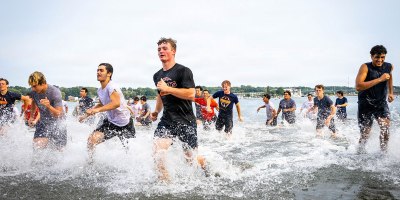 Participants of The Connecticut National Guard's annual football camp run through the Niantic River during training at Camp Nett in Niantic, Connecticut, August 24-30. The camp combines military training techniques with standard football practice to help students and young athletes build the discipline and leadership skills as they go into the upcoming season.