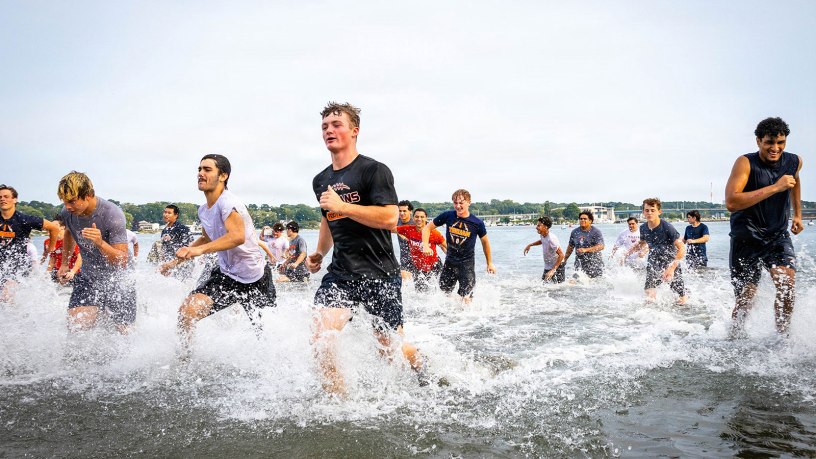 Participants of The Connecticut National Guard's annual football camp run through the Niantic River during training at Camp Nett in Niantic, Connecticut, August 24-30. The camp combines military training techniques with standard football practice to help students and young athletes build the discipline and leadership skills as they go into the upcoming season.