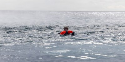U.S. Air Force Senior Airman Spenser Ferguson, attached to the 31st Operations Support Squadron, simulates an isolated person in a maritime recovery scenario, enabling training for North Atlantic contingency operations on land or at sea during exercise Northern Viking 26 (NV26) in Keflavik, Iceland, Aug. 28, 2026.