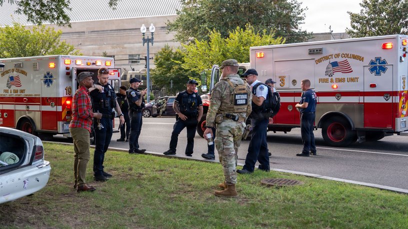 U.S. Army National Guardsmen assigned to Joint Task Force-District of Columbia (JTF-DC) in support of the DC Safe and Beautiful mission, provide medical support alongside Metro Police Department and Emergency Medical Services during a car accident at the DC Armory in Washington, Aug. 28, 2026.