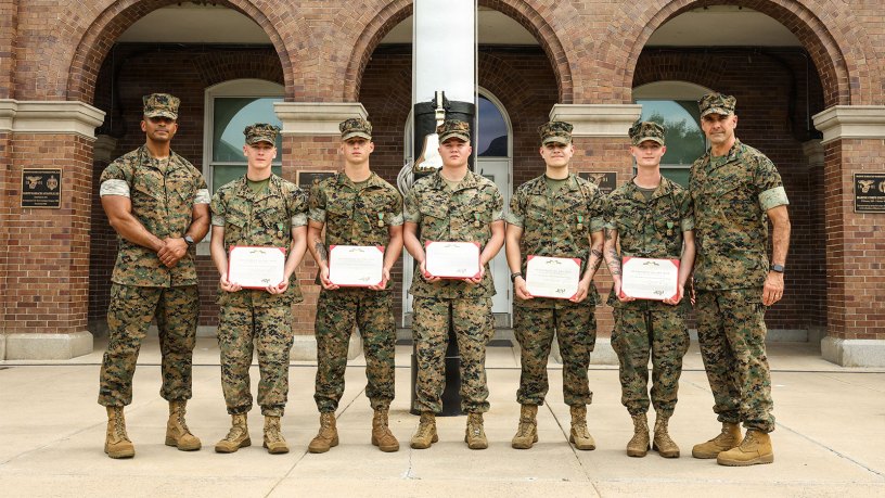 U.S. Marines with Guard Company, Marine Barracks Washington pose for a photo with Sgt. Maj. Juan P. Segura, sergeant major, Marine Barracks Washington, left, and Col. Jason Copeland, commanding officer of Marine Barracks Washington, right, after an award ceremony at Marine Barracks Washington, D.C., Sept. 3, 2026.