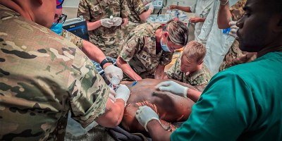 U.S. Army Staff Sgt. Nicholas Koo, a combat medic with the 915th Forward Resuscitative Surgical Detachment, 313th Hospital Center, 2nd Medical Brigade, stabilizes a critically burned patient alongside U.S. Army Reserve and Angolan Armed Forces medical professionals at Hospital Militar Principal in Luanda, Angola, Sept. 4, 2026.