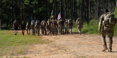 U.S. Army Soldiers march for the 2026 9/11 memorial PSYOP Regimental Ruck March, at Fort Bragg, North Carolina, Sept. 10, 2026. During the ruck march the flag is moved between units and soldiers for a continuous 24 hours. (U.S. Army photo by Spc. Sydney Sepulveda)